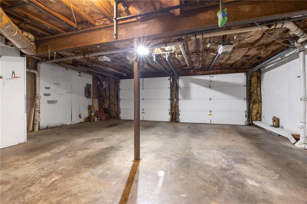 Garage with electric panel and a garage door opener
