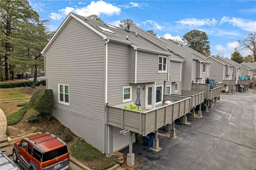 Back of property featuring a residential view and a wooden deck