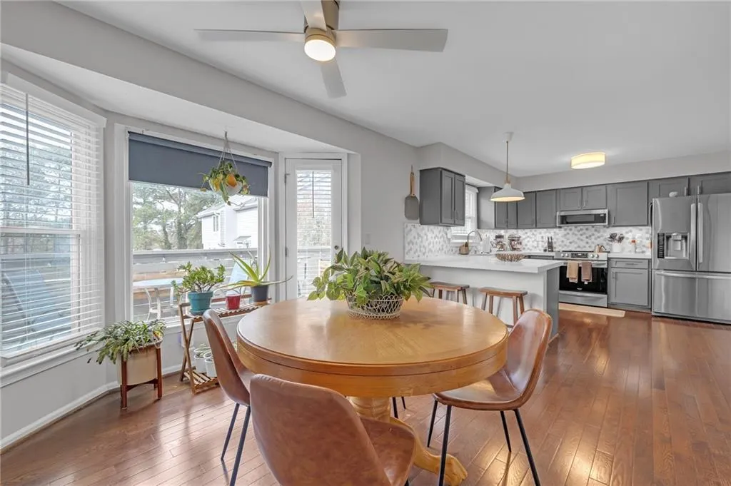 Dining room featuring dark wood-type flooring and a ceiling fan