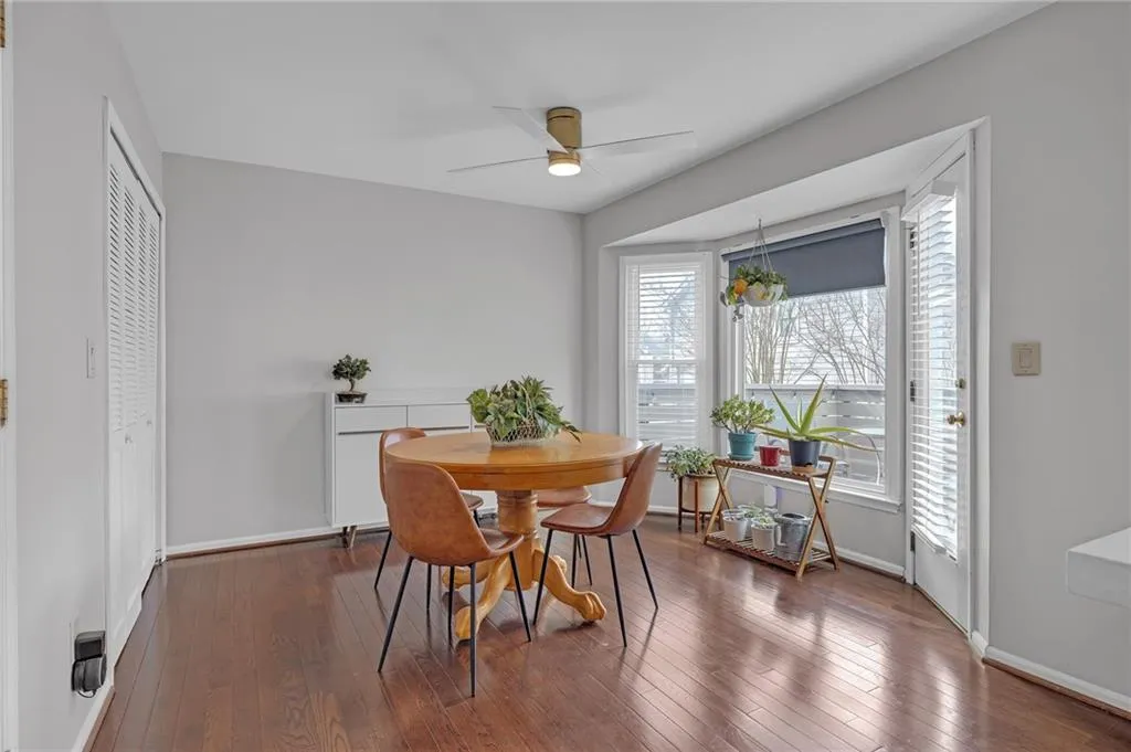 Dining room featuring ceiling fan and dark wood-type flooring