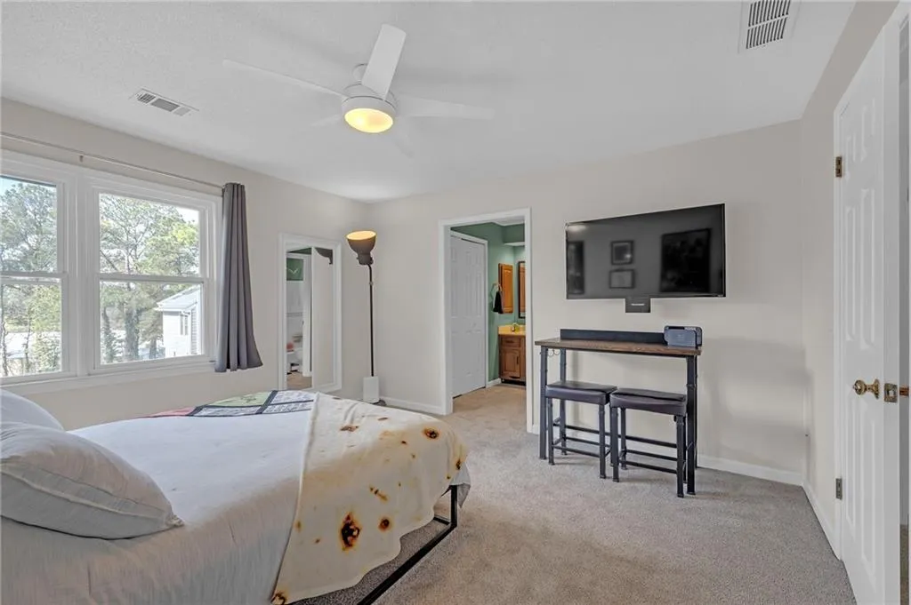 Bedroom featuring light carpet and a ceiling fan