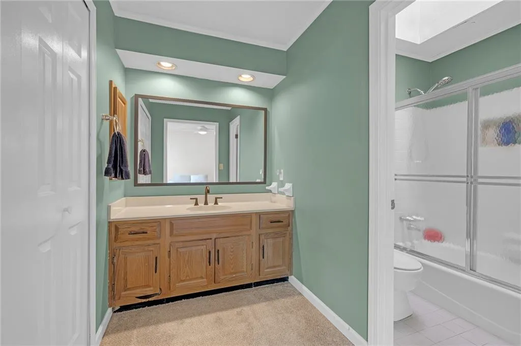 Full bathroom with crown molding, vanity, combined bath / shower with glass door, recessed lighting, and light tile patterned floors