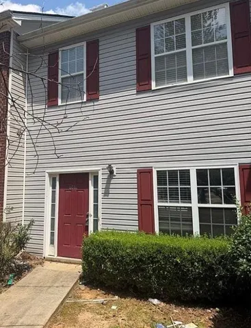 Gray horizontal siding exterior with contrasting red shutters