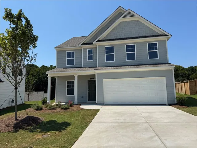Two-story residence with a covered front porch, an attached two-car garage, and a concrete driveway