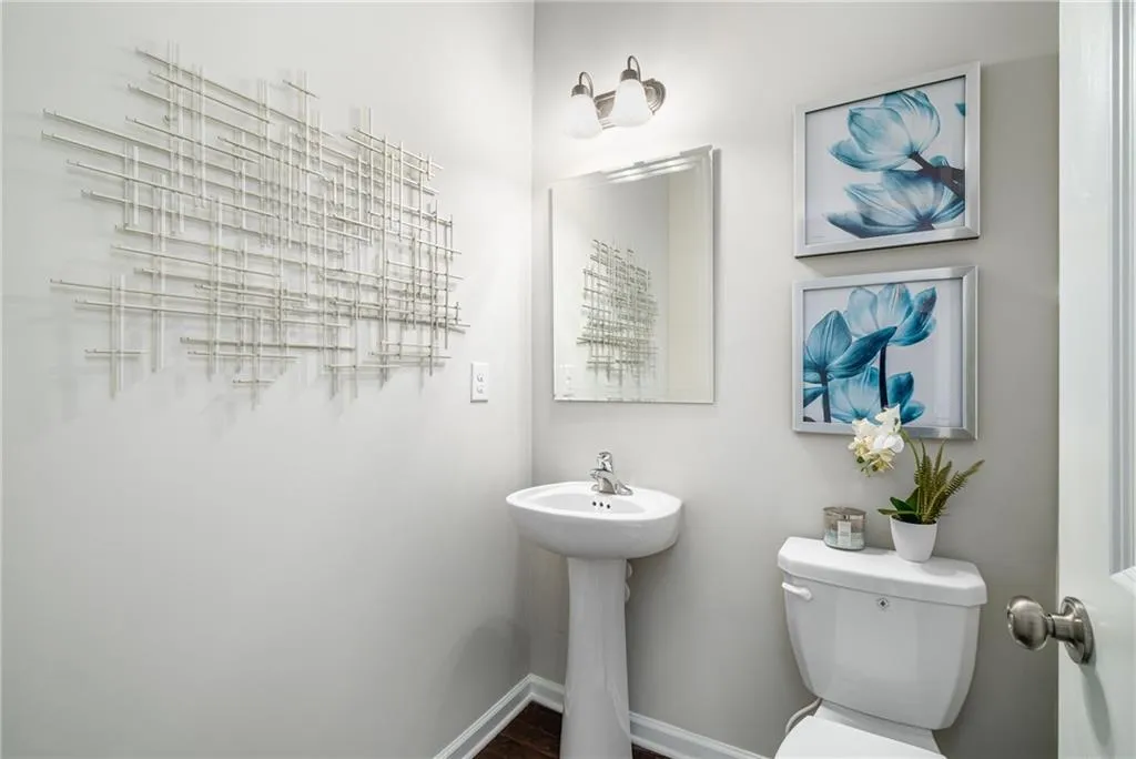 Half bathroom featuring toilet and baseboards