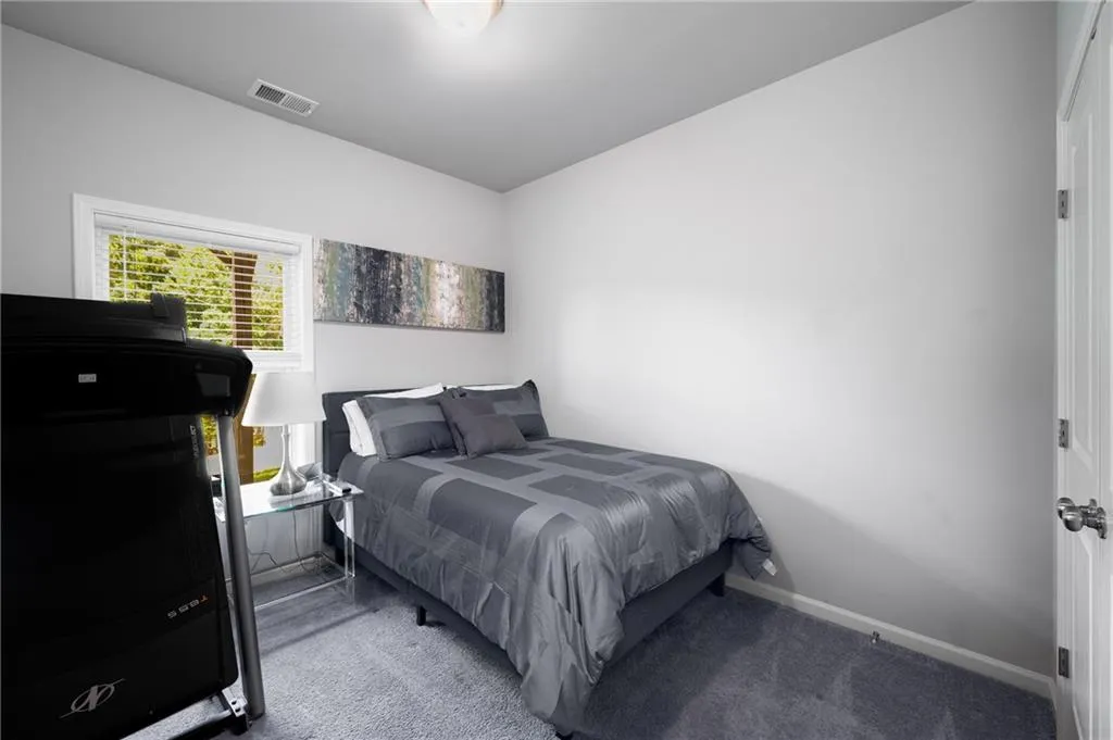 Carpeted bedroom with baseboards