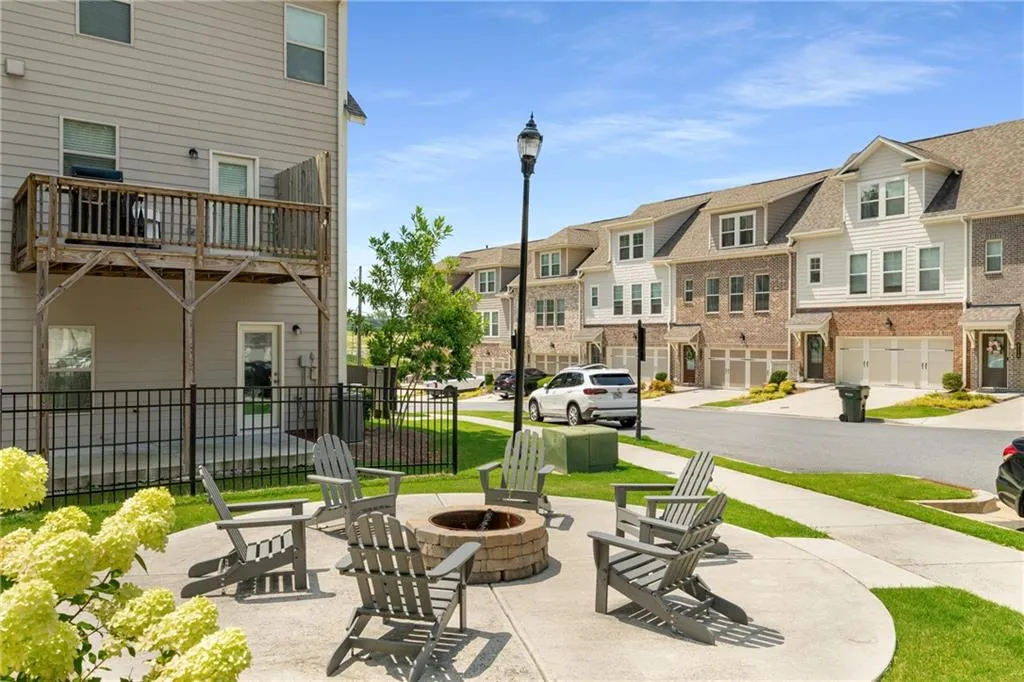 View of community featuring an outdoor fire pit and a residential view