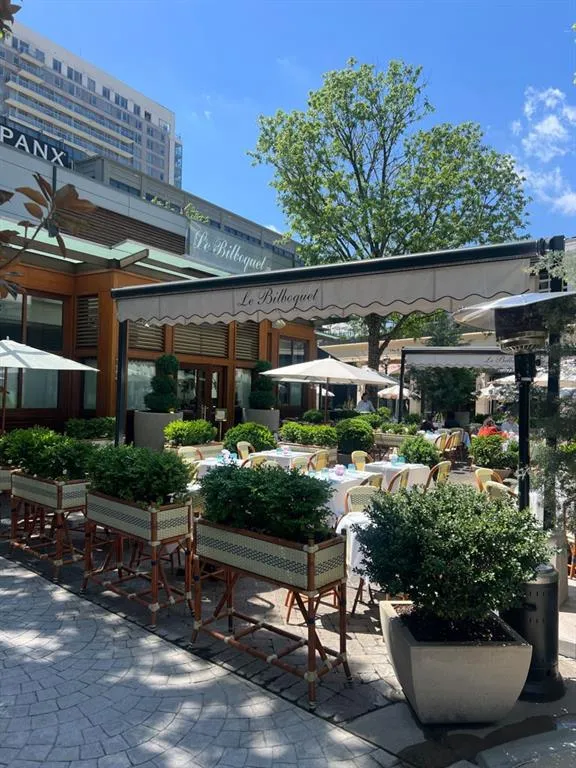 View of community with a patio area and outdoor dining space