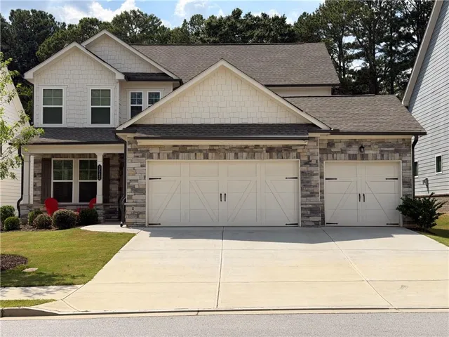 Stone and shake siding facade with a gabled roofline