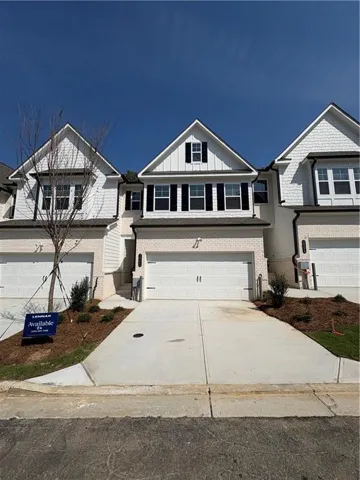 White brick and shingle exterior with black shutters