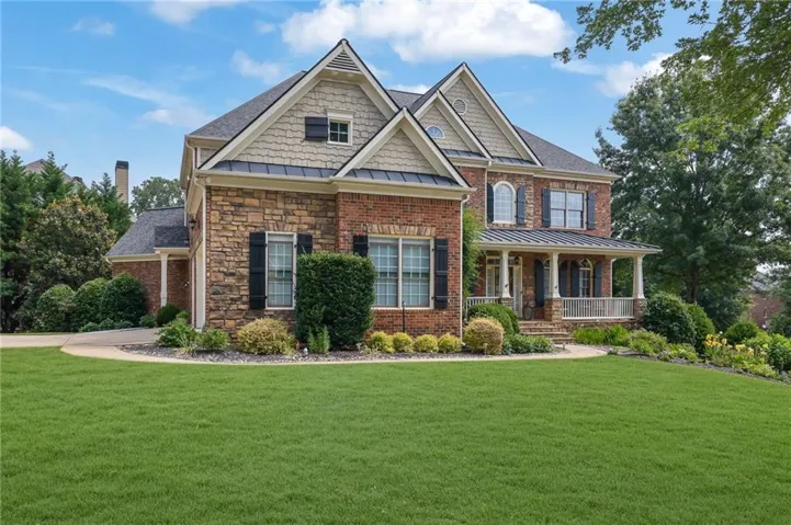 Brick and stone exterior featuring multiple gables