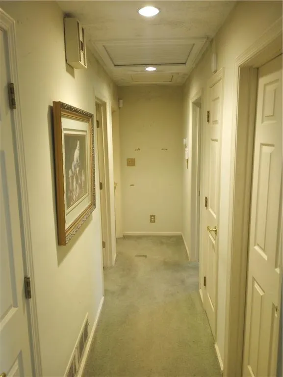 Corridor featuring carpet floors, attic access, and recessed lighting
