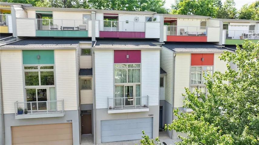 Modern townhome exterior featuring multi-level design and vibrant accent panels