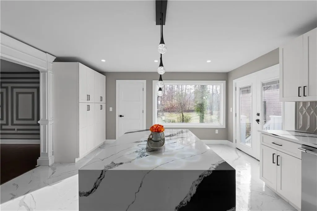 Dining area with light marble finish flooring, recessed lighting, and french doors