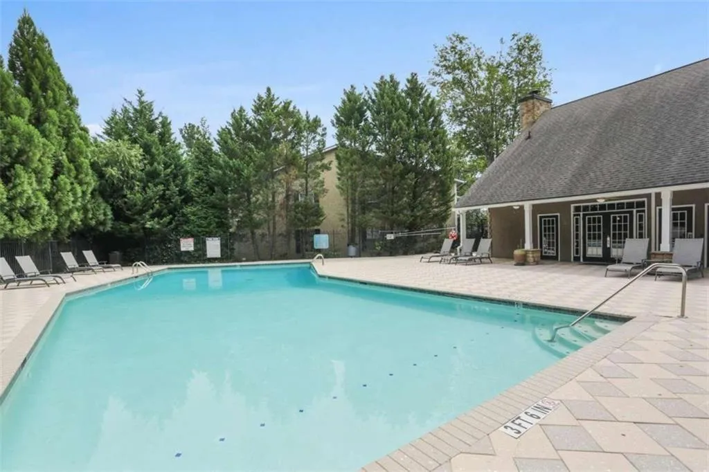 Community pool with a patio area