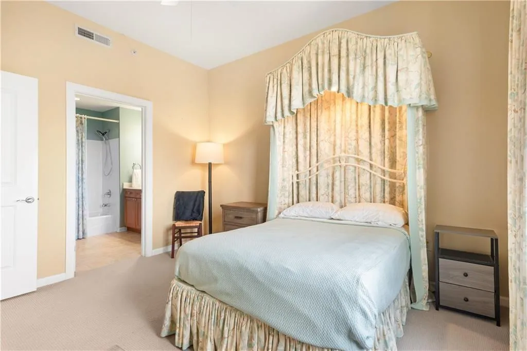 Bedroom featuring carpet and ensuite bath
