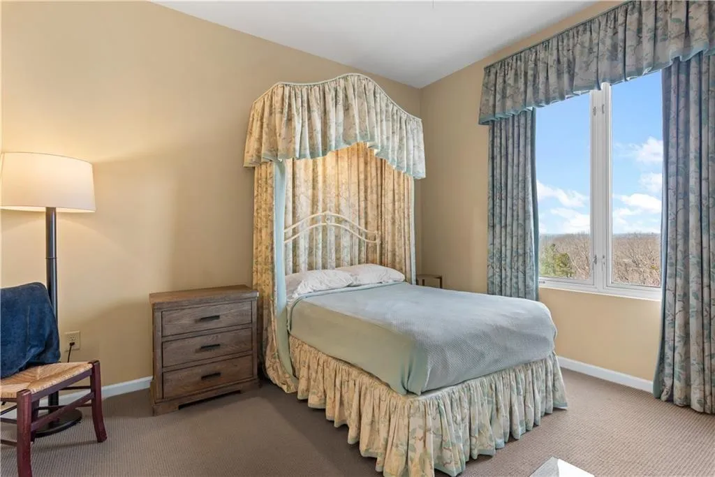 Carpeted bedroom featuring baseboards