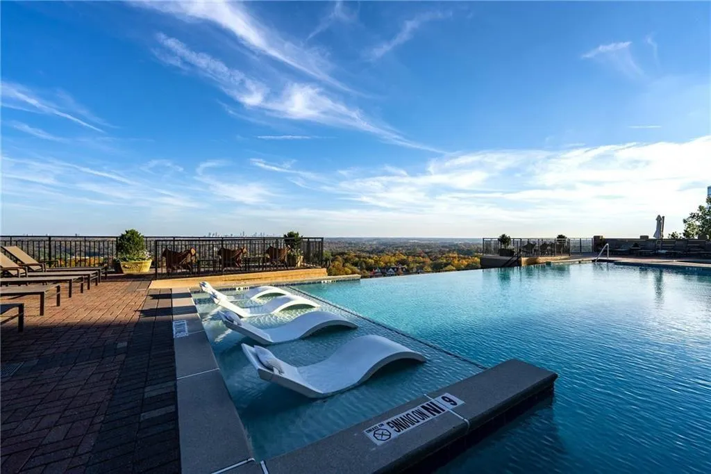 Community pool featuring a hot tub and a patio area