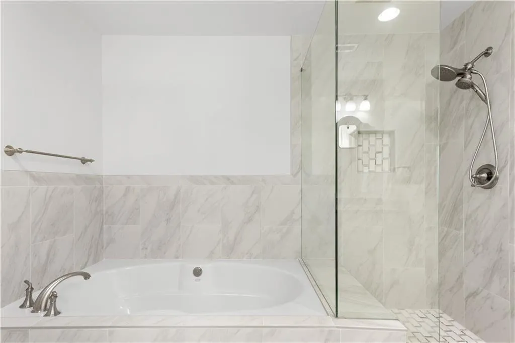 Full bath with a bath and a tile shower