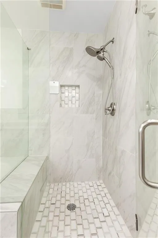Full bathroom featuring a shower stall