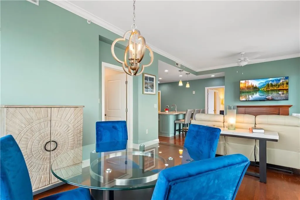 Dining room with crown molding, dark wood-style floors, a ceiling fan, and recessed lighting