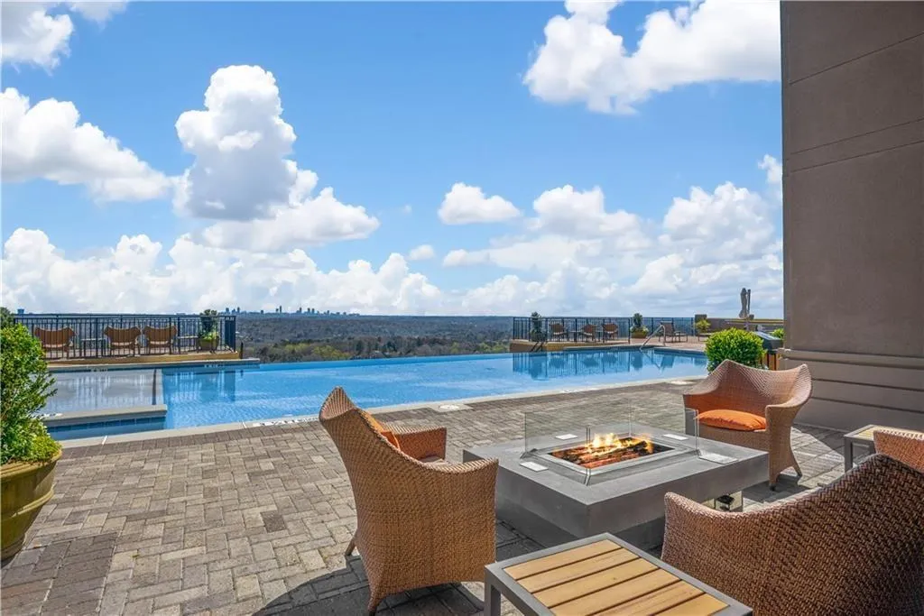 Community pool with an outdoor fire pit and a patio