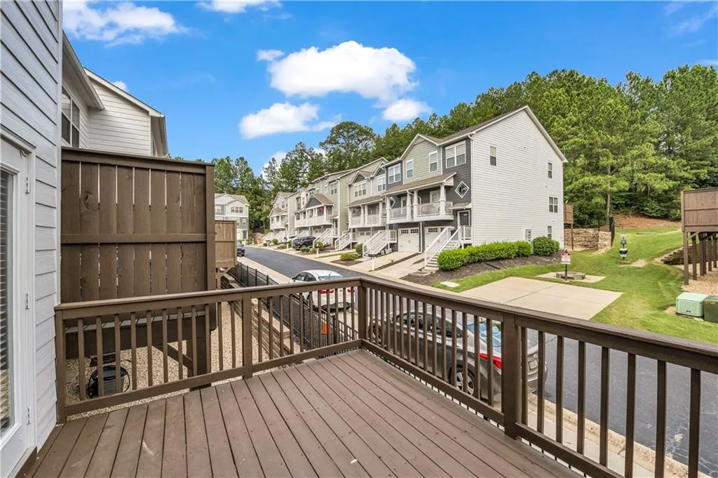 Wooden terrace featuring a residential view and a yard