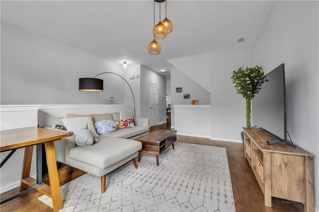 Living area with wood finished floors and baseboards