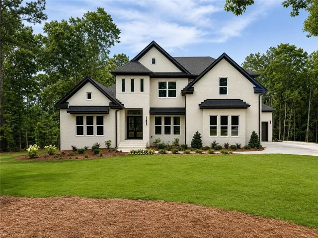 Contemporary exterior design featuring white brick with black trim accents and a dark shingle roof