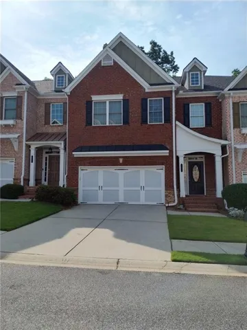 Brick exterior with a prominent two-car garage
