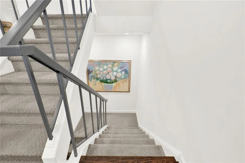 Stairway with carpet and baseboards