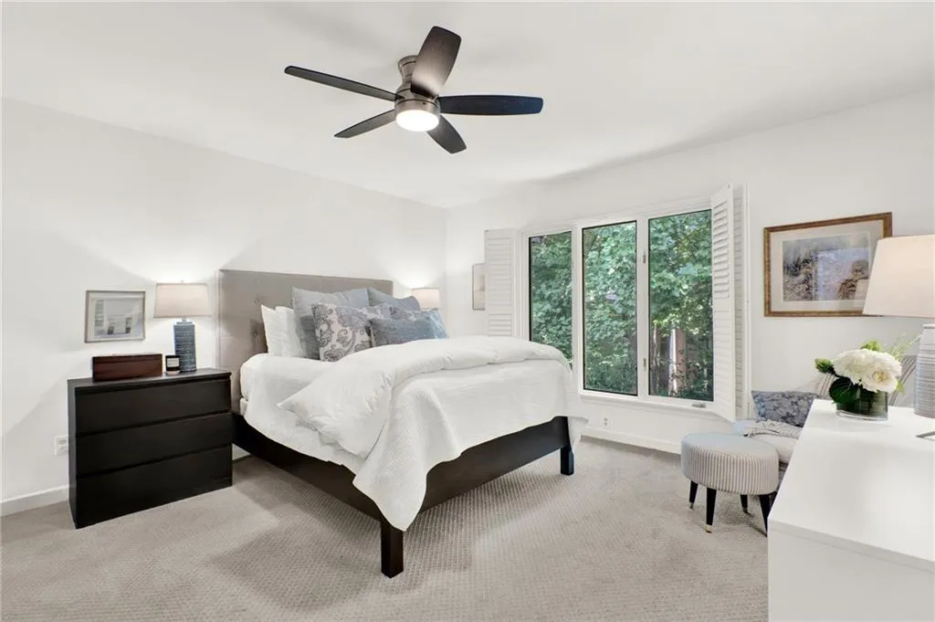 Bedroom with light colored carpet and ceiling fan