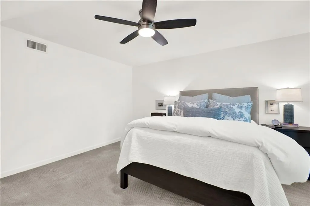 Bedroom with carpet and a ceiling fan