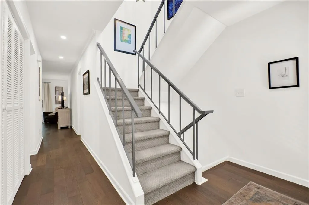 Stairway with hardwood / wood-style flooring and recessed lighting