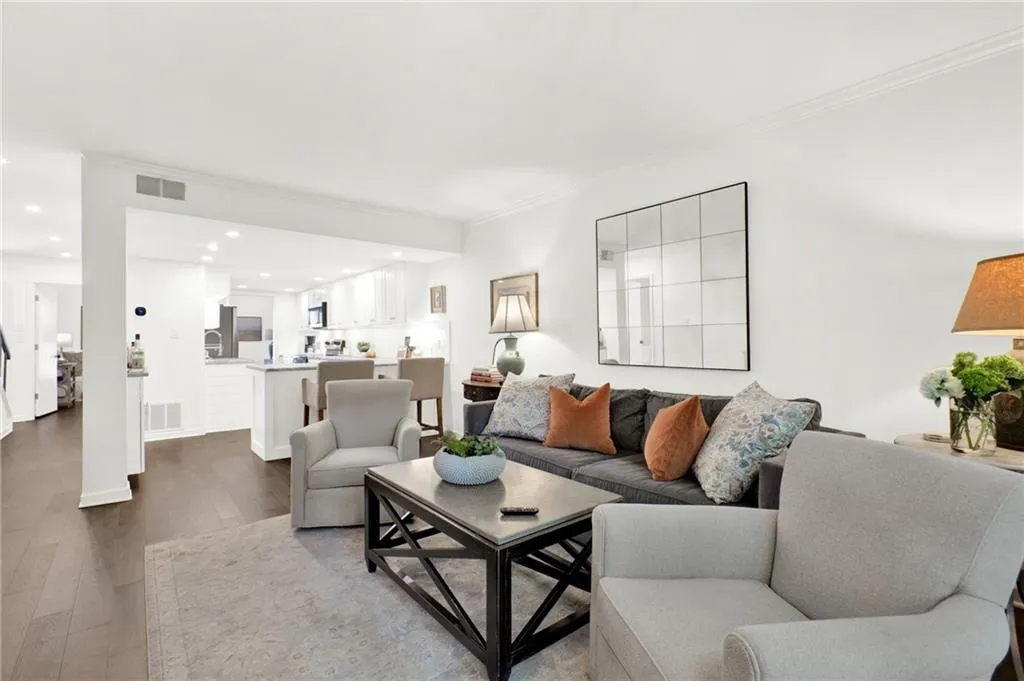 Living area featuring crown molding, recessed lighting, and dark wood-style floors