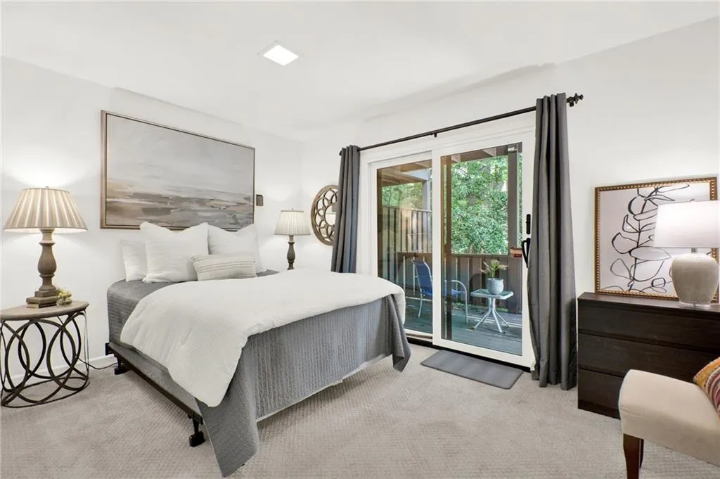 Bedroom featuring carpet and access to exterior