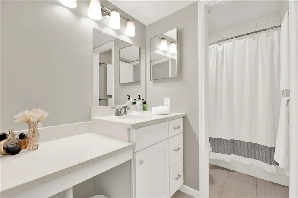 Full bathroom featuring vanity and curtained shower