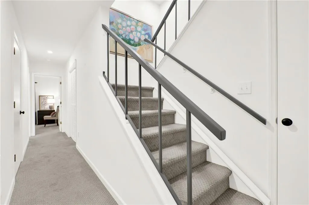 Stairs with carpet and recessed lighting