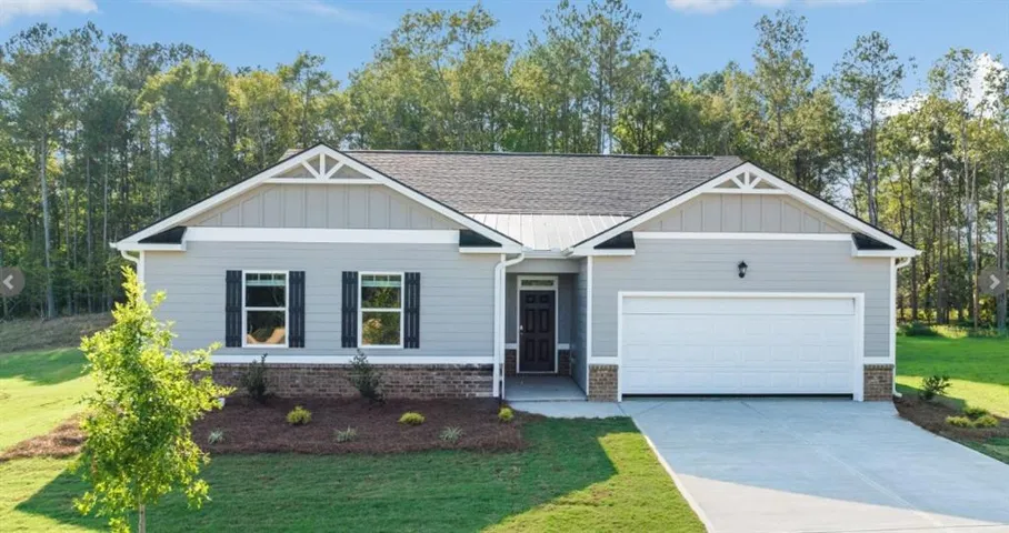 Contemporary ranch-style residence featuring light gray siding, dark gray shutters, and a brick skirt
