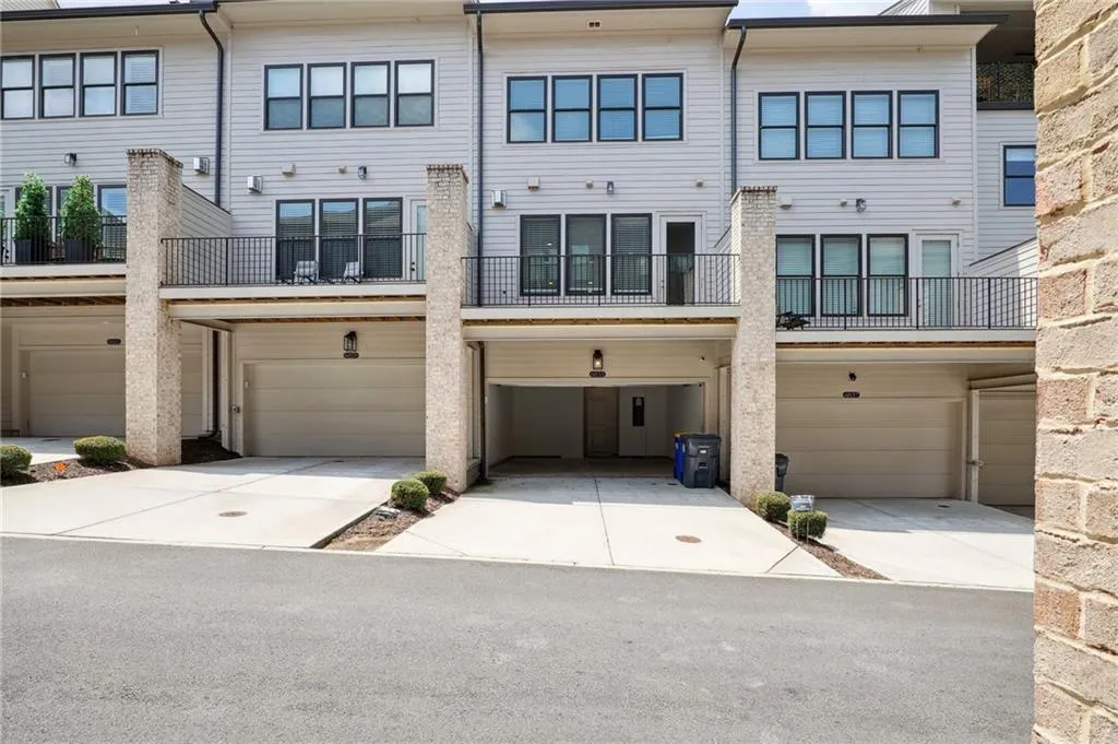 View of front facade with a balcony and a garage