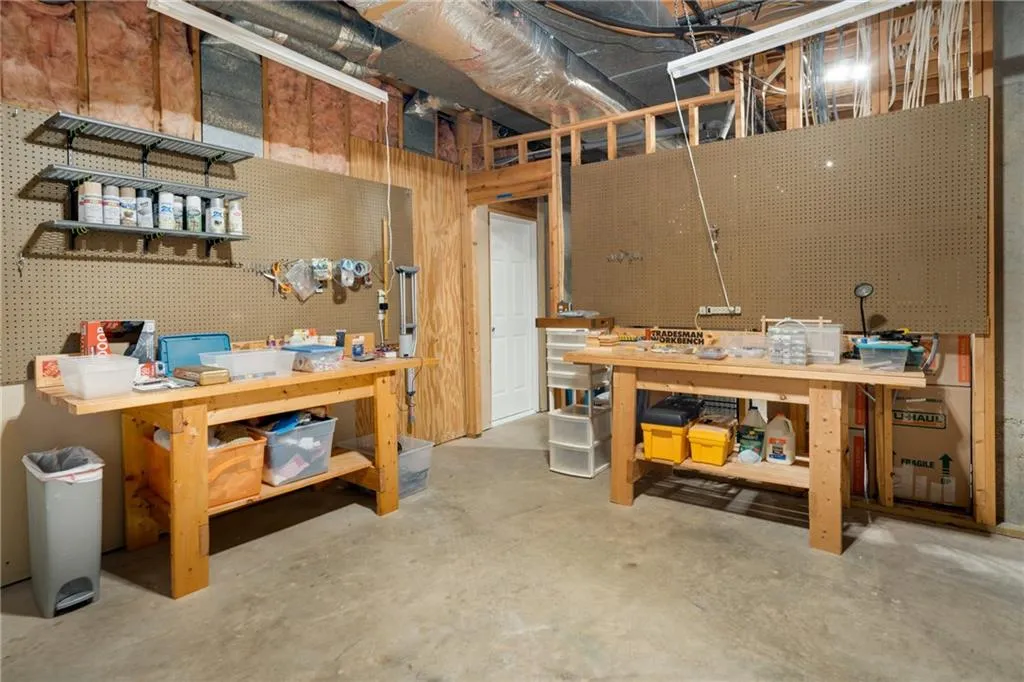 Unfinished below grade area featuring a workshop area.