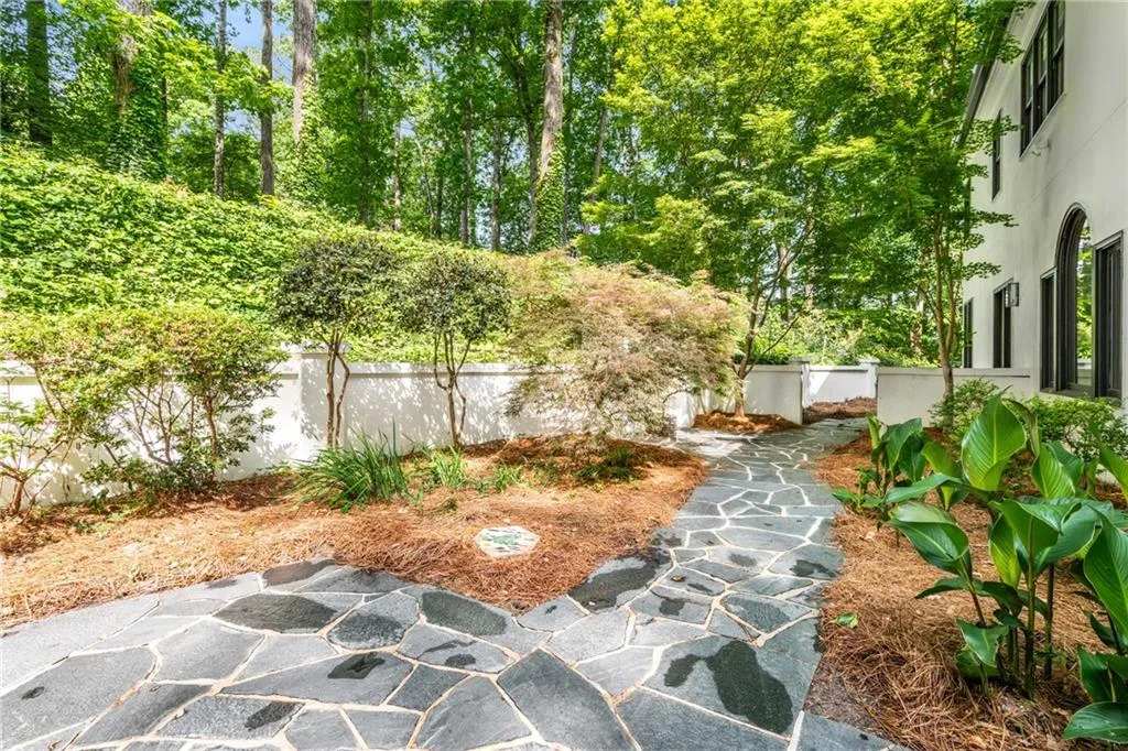 900 Edgewater Drive~ Charming patio wraps around the back of the home and creates the perfect outdoor living area- great for entertaining.