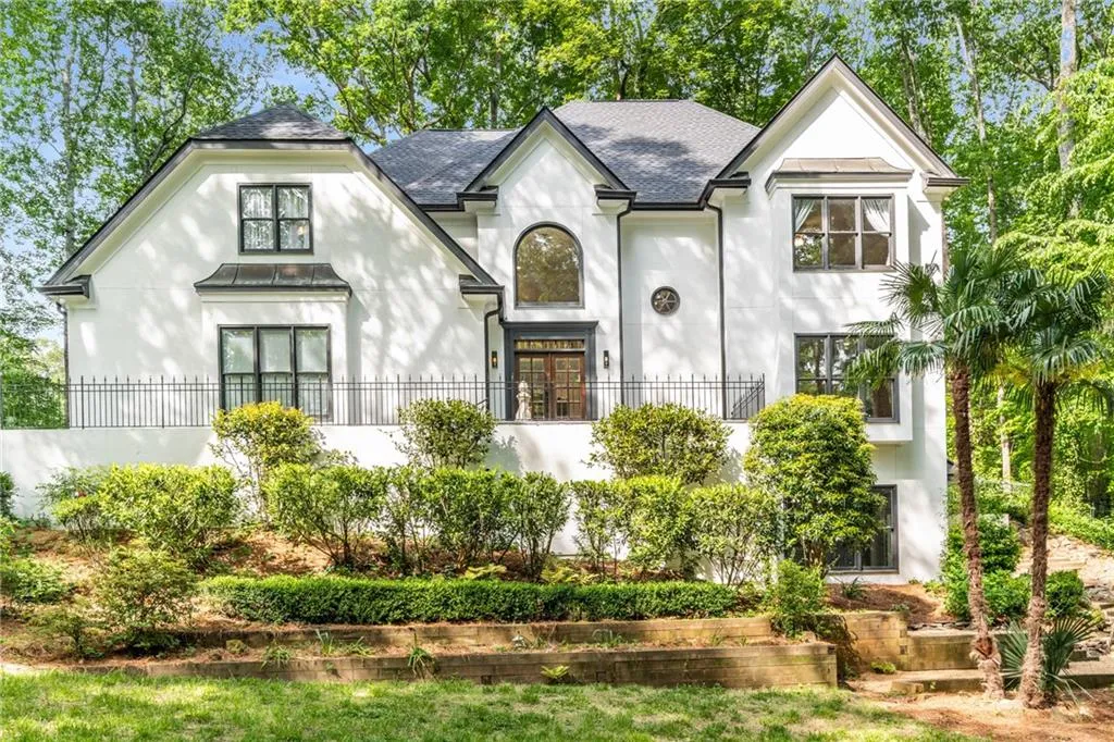 900 Edgewater Drive~ Tucked away on a winding driveway, this beautifully updated European-style home offers privacy, charm, and over 3500 square feet of stylish living.
