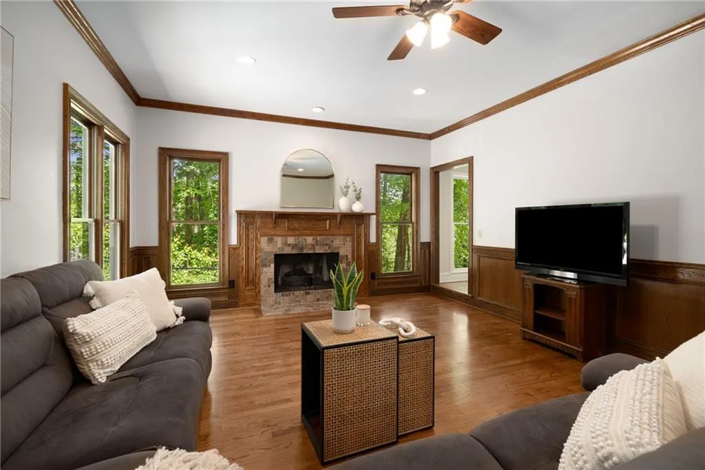 900 Edgewater Drive~ The fireside Family Room overlooks the private yard with a pass-through to the Living Room.
