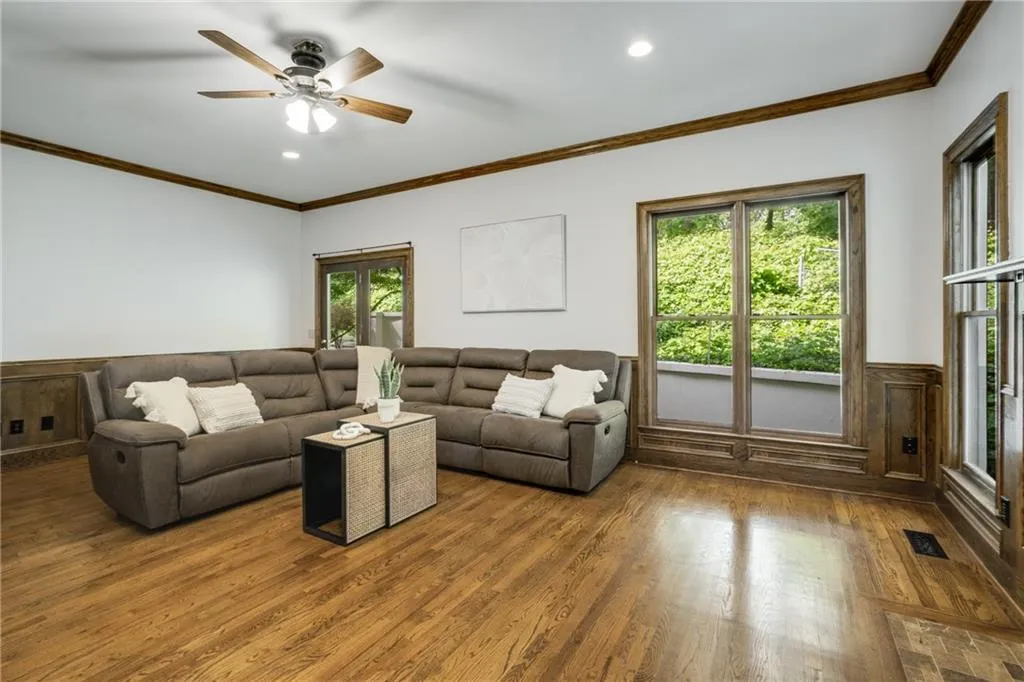 An alternate view of the large family room which is enveloped by light and the greenery of the home's lot.