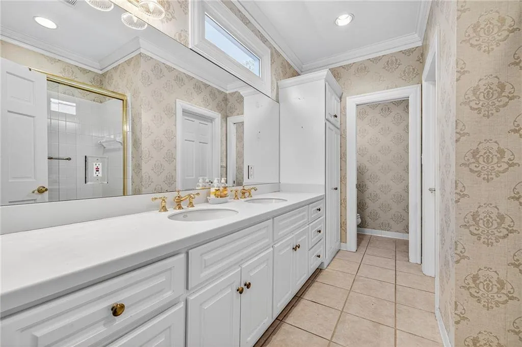 Upper level bathroom with dual vanities is shared with third bedroom