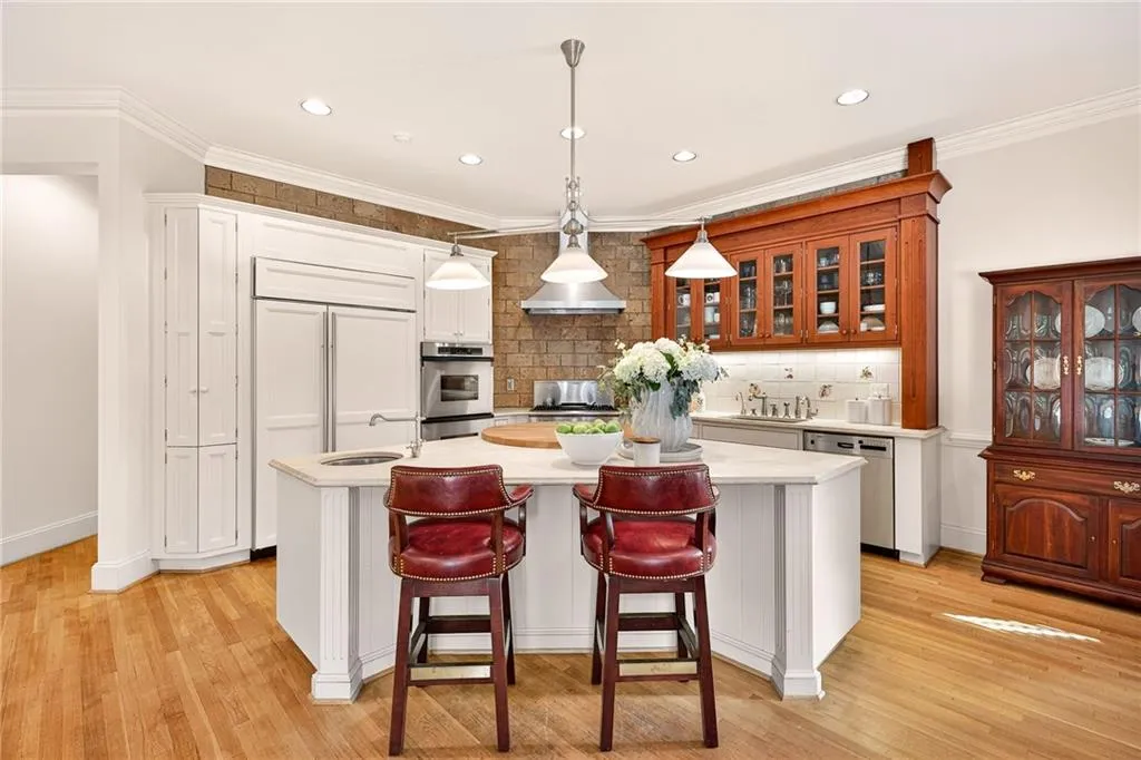 Open kitchen with large island, paneled appliances and walk-in pantry