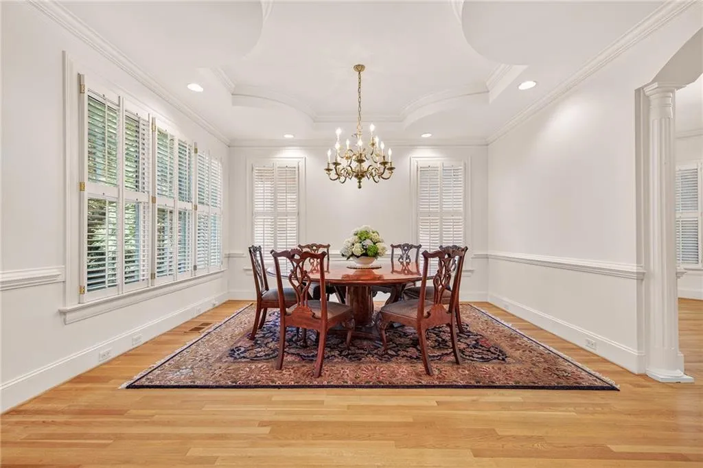 Secondary view of dining room with vintage brass chandelier