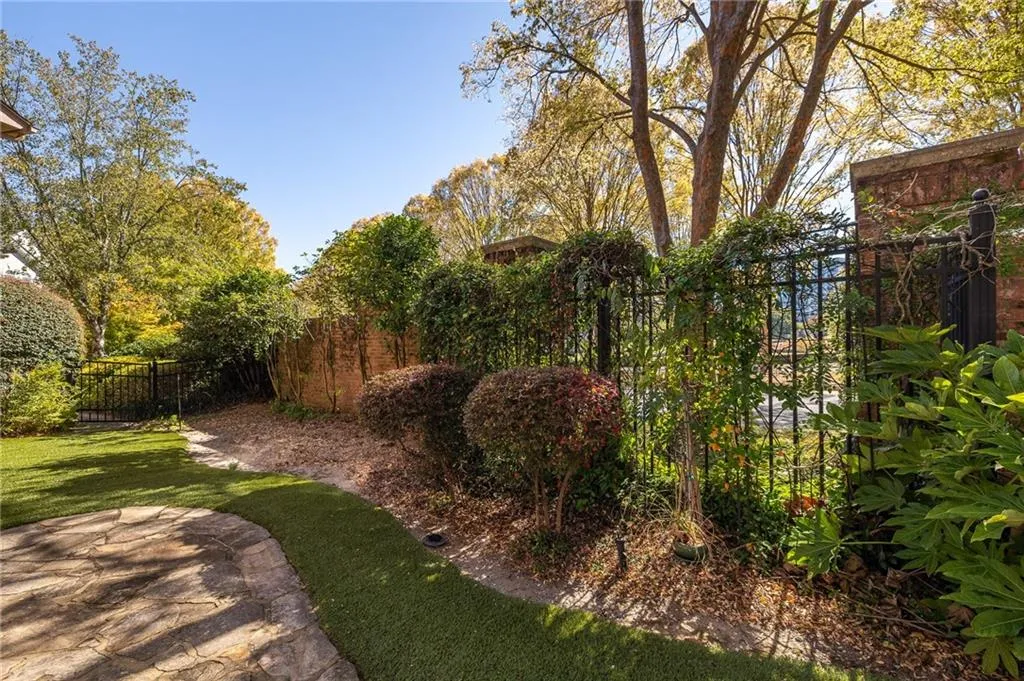 Private fenced green space area with artificial turf for low maintenance year round