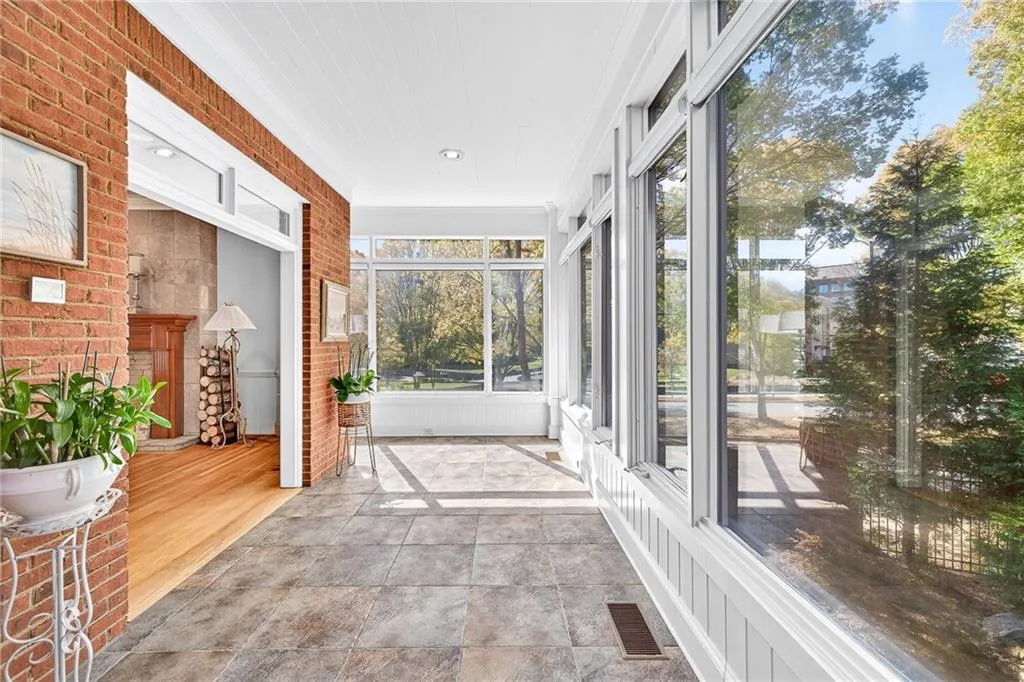 One of two sunrooms with wall of windows and gorgeous view